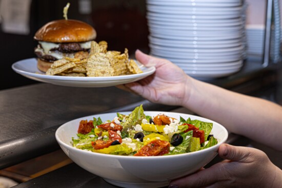 Enjoy the Wagyu beef burger and crisp salad.