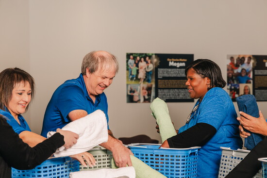 Giving Grace staff members sorts through items for clients. 