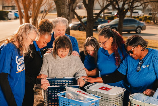 Giving Grace team prays over their client's items.