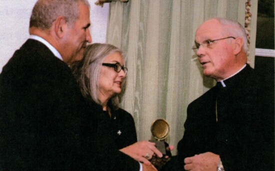 John & Bobbi Sfire receiving the Spirit of St. Martin de Porres Award from Bishop George Rassas.