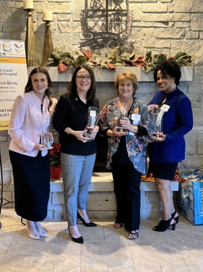 Accepting for Linda Gump (left) is Monica Gump (daughter) with winners Mary Brennan, Leslie Ferris Yerger, and Traci Sanders Campbell.