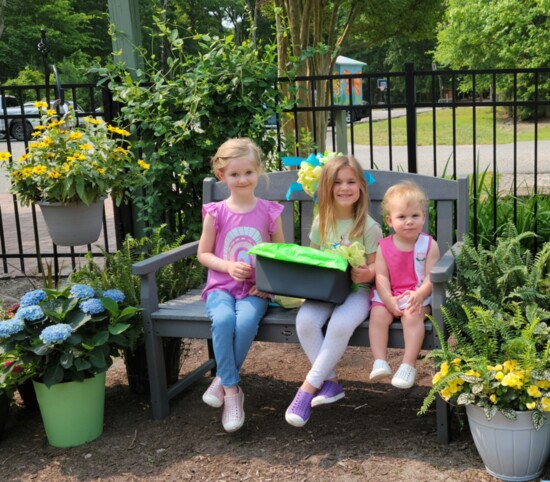 Children sit on the bench donated by the Salisbury Garden Club.