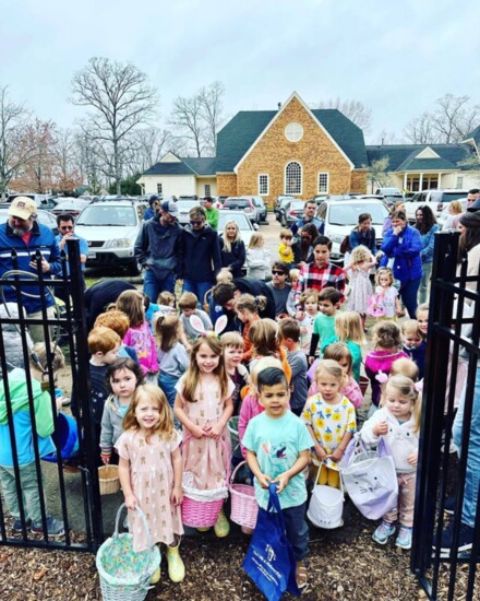 Children gather for an Easter egg hunt at Wishing Well Park.