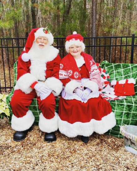 Santa and Mrs. Claus visit Wishing Well Park.