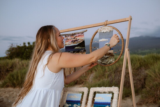 Angie Daul alongside her yarn-weaving art work