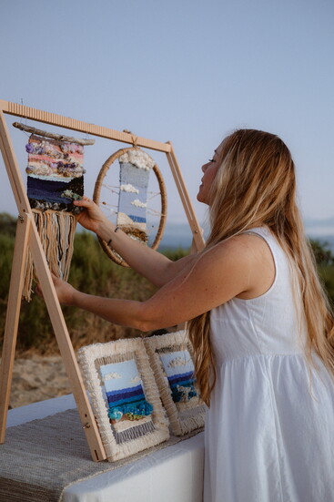 Angie Daul alongside her yarn-weaving art work