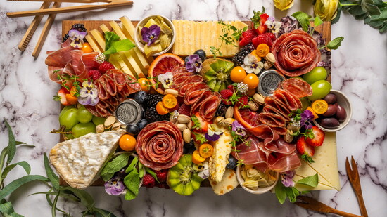 A complete grazing board with a colorful assortment of foods.