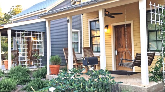 Sweet-scented moonflowers bloom in front of a cottage at Hill Country Herb Garden and Spa in Fredericksburg, Texas.