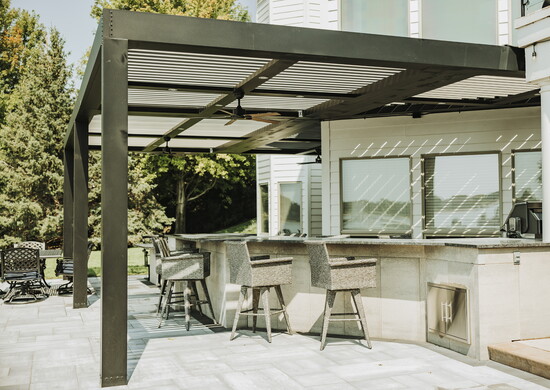 Under a custom StruXure Pergola X, this outdoor space by Ground Builders invites year-round connection, rain or shine