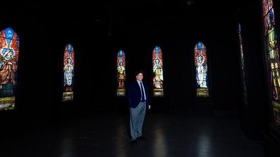 Dr. Scott Peck stands among Tiffany Studios’ Seven Angels of Revelation at the Museum of Biblical Art.
