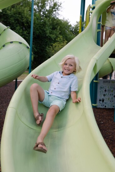 Asher Anderson (4), son of Brad Anderson and Anna VanHorn, is all smiles, sliding on the new play structure. 