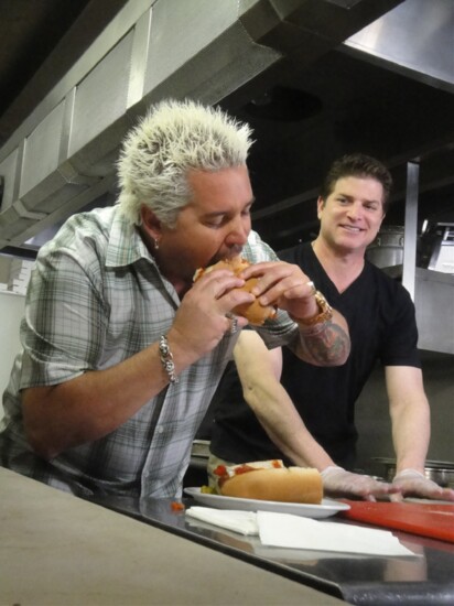 Host Guy Fieri tastes a sandwich in Scottsdale, as seen on Food Network's Diners, Drive-Ins and Dives