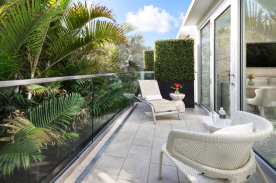 A private balcony or terrace provides a perfect spot to savor the tropical breeze