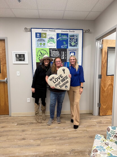 Habitat homeowner Connie Baker with Casey King of Watersound Title Agency (left) and Teresa Jones.