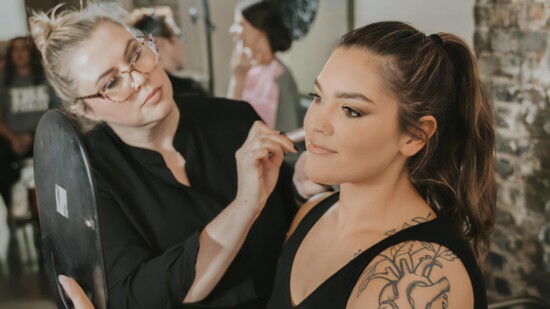 Delcina enhances a client with makeup customized to her
