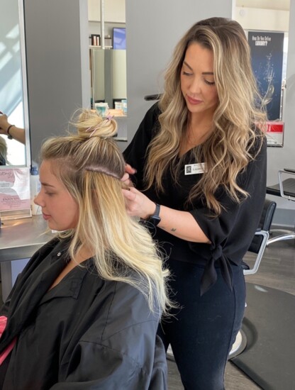 Stylist, Lauren Keck applying hair extensions