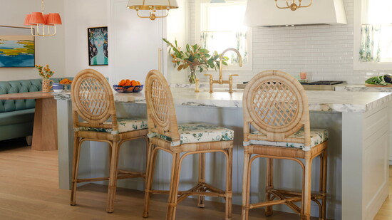 Pops of blue and orange add a burst of color to this kitchen designed by Hallie Henley Sims of Hallie Henley Design.