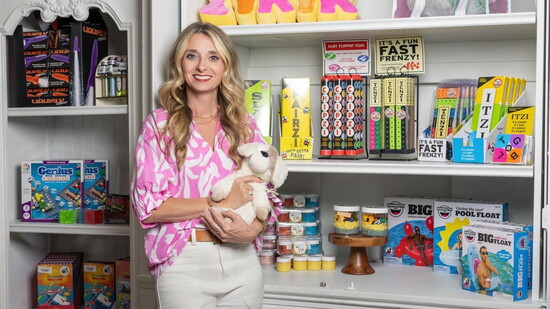Tanya Carter poses with a display of kids' items in her store.