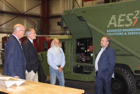 Mike Watts with community leaders. Photo courtesy of AES2. 