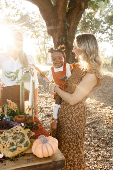 Caroline shows off her carrot to her mother, Anna Coomes