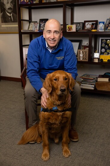 Facility dog Jim Dandee works right along with Dr. B in leading and encouraging students and staff.