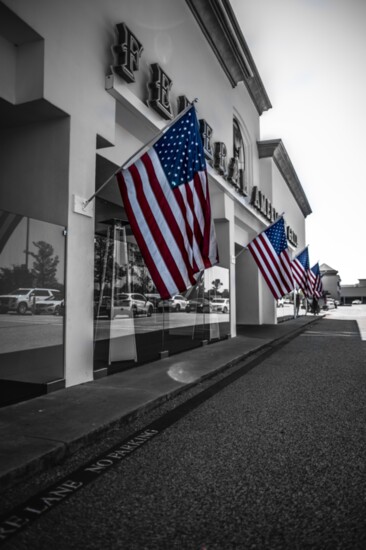 Flags wave patriotically in front of the Federal American Grill.