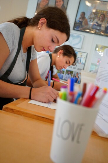 Healing Meals volunteers write notes that will accompany each donated meal. 