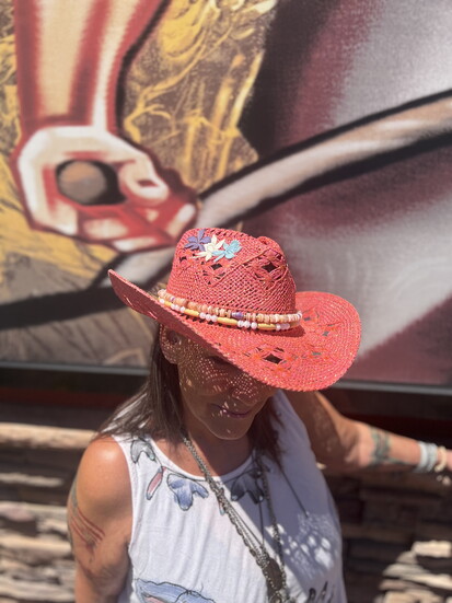 Janet posing in one of her custom hats.