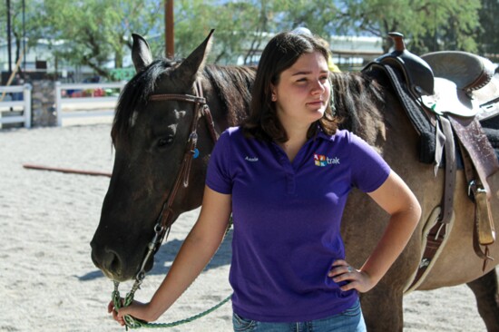 TRAK volunteer Annie Horvath stands with one of the horses used during the summer camp program.