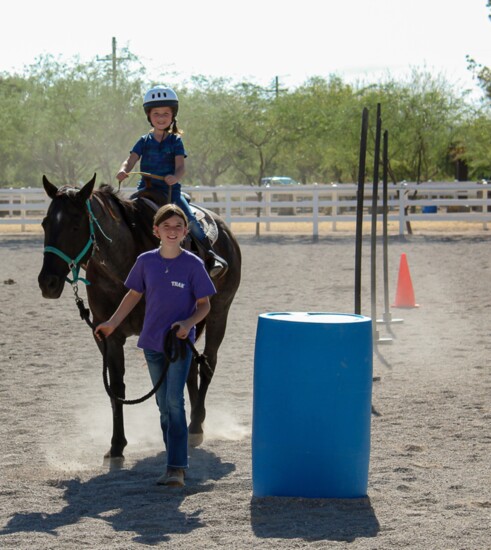 Callie is happily led through the obstacle course by TRAK volunteer Alex Harvey.