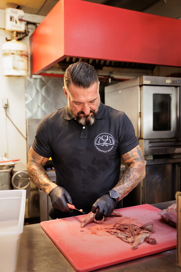 Chris Ideson, prepping meat for customer's meals