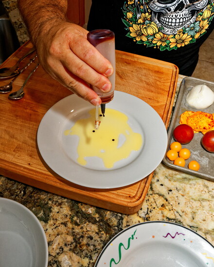 Chef Chris finishes with a drizzle of pomegranate reduction, highlighting the burrata’s delicate richness.