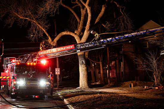 Firefighters break down equipment after a structure fire in Greeley