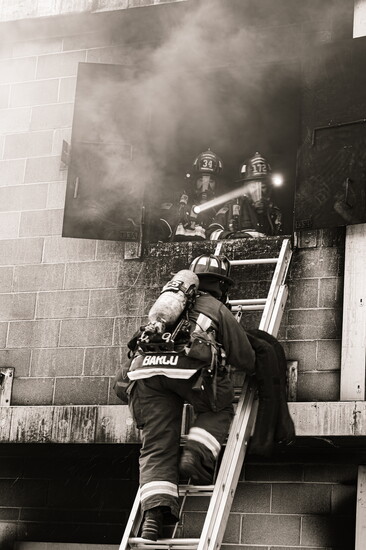 Greeley firefighters conducting victim rescue operations through a window during live burn training