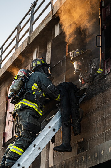Greeley firefighters conducting victim rescue operations through a window during live burn training