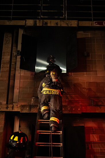 Greeley firefighters conducting victim rescue operations through a window during live burn training