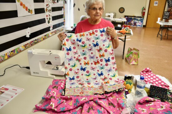 Louise Moody shows pillowcases she’s made as part of the group’s current community service project. The pillowcases will be donated to Oklahoma Children’s Hospi