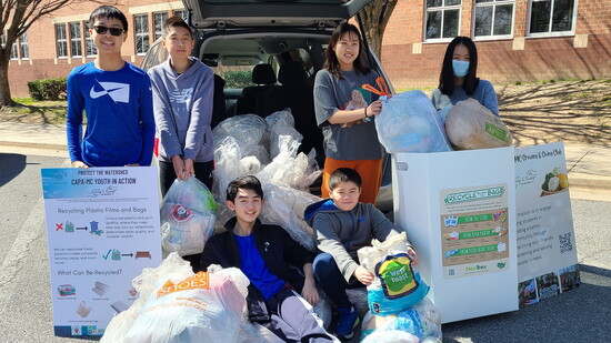 Club members collecting plastic bags at a local High School