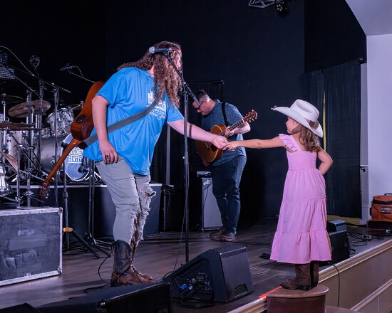 A young girl presents Ryan Bam with a donation during the Hometown Jam.