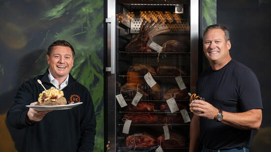 Scott Slater (L) and Todd Kellinsky showcase Hemlock’s dry-aged cuts and tableside Signature Potato Cart