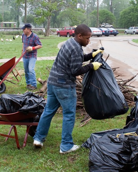 Volunteers clean up debris in Memorial Park from the flood of May 2010.