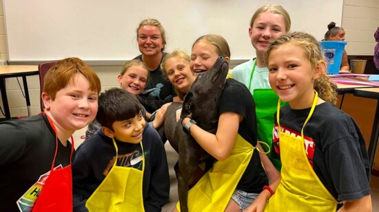 Kids snuggle with a Hero Dog.