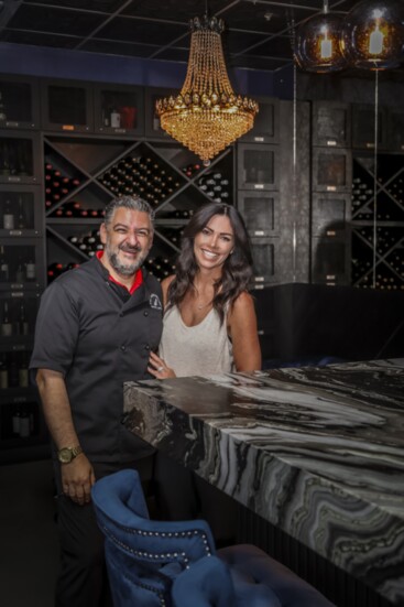 Fuhgeddaboudit owner, Faith Catalano (R) with her husband, Angelo (L) at the bar in their speakeasy-style wine bar and lounge in Wildomar.