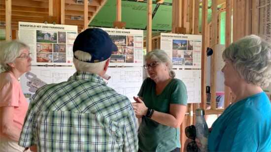 A Wolfworks employee explains a building project. 