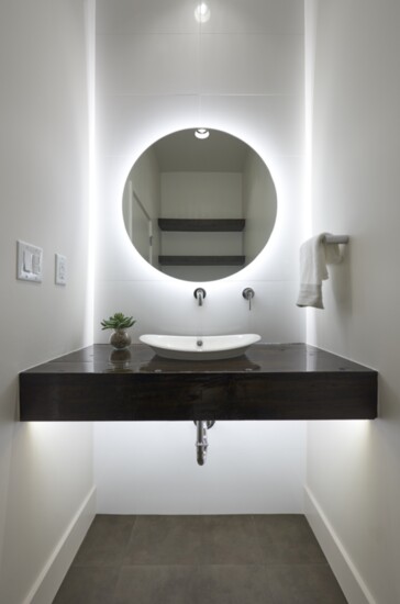 The spa bathroom, professionally designed lighting, and the stainless-steel galley-style sink make the home beautiful as well as functional.