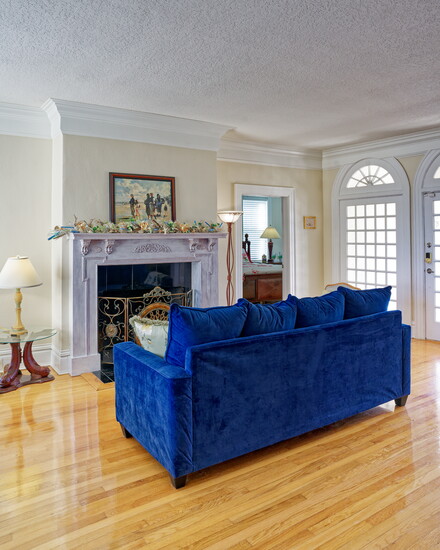 Built in 1918, the Prettyman House's foyer welcomes guests with a wood-burning fireplace and comfortable, stylish seating overlooking the Atlantic Ocean
