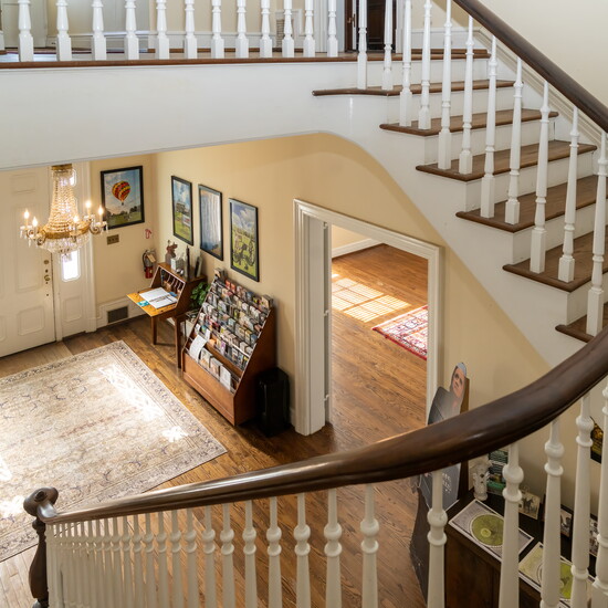 The sweeping stairwell looks toward the entrance that greets visitors upon their arrival.