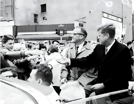 View of Senator John F. Kennedy visiting Mount Clemens during the 1960 Presidential election campaign. The back of the Jewel Theater is seen in the background.