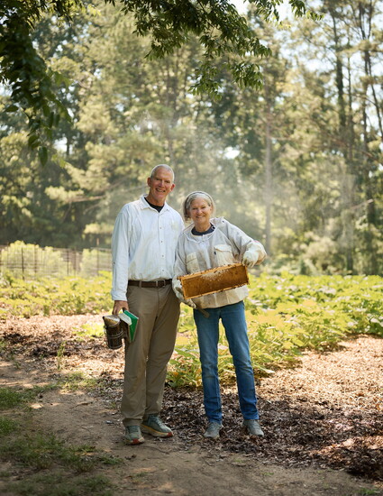 The Humphries at a Pineville farm, where the bees pollinate an acre of vegetables harvested and donated to The Bulb.