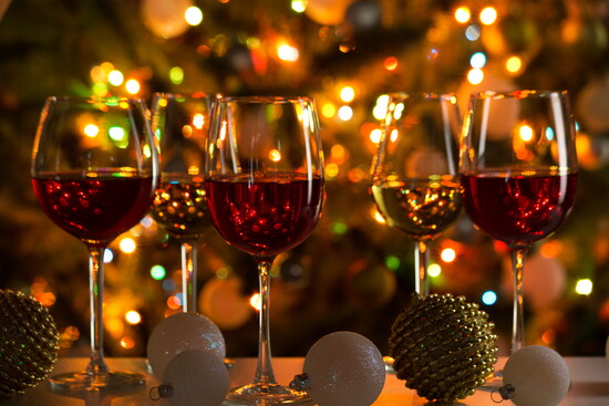 Various wines with holiday lights and ornaments.
